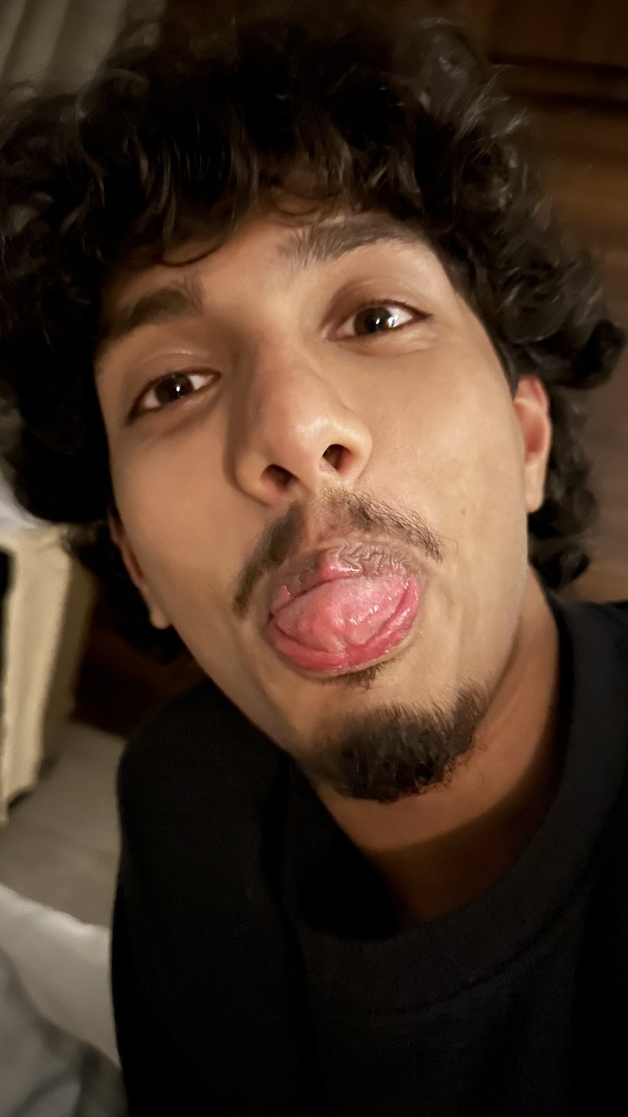 Krish Thakker sticking his tongue out at the camera